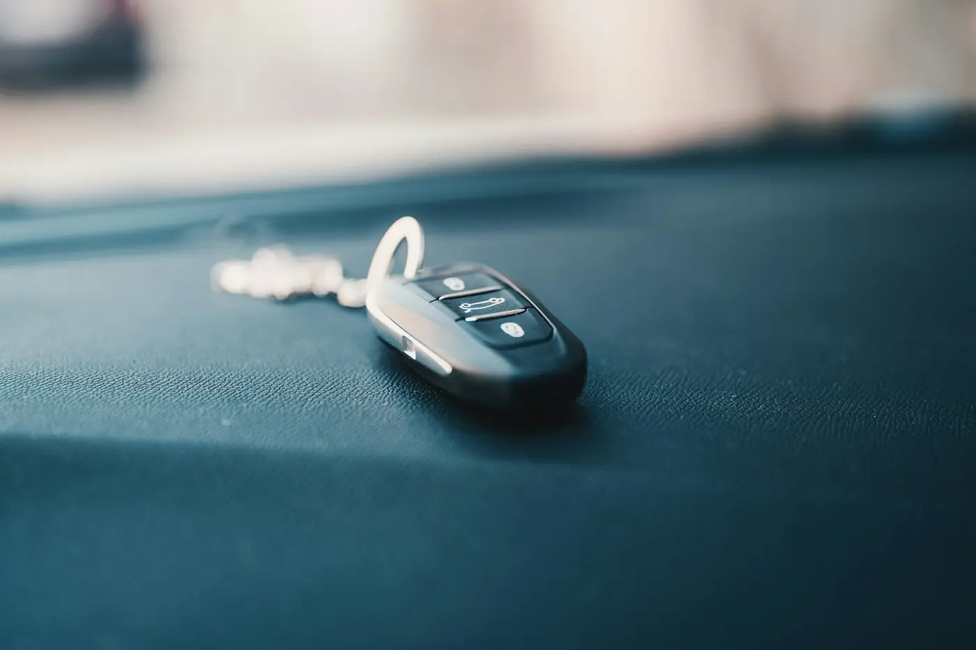 Car key and remote resting on a seat